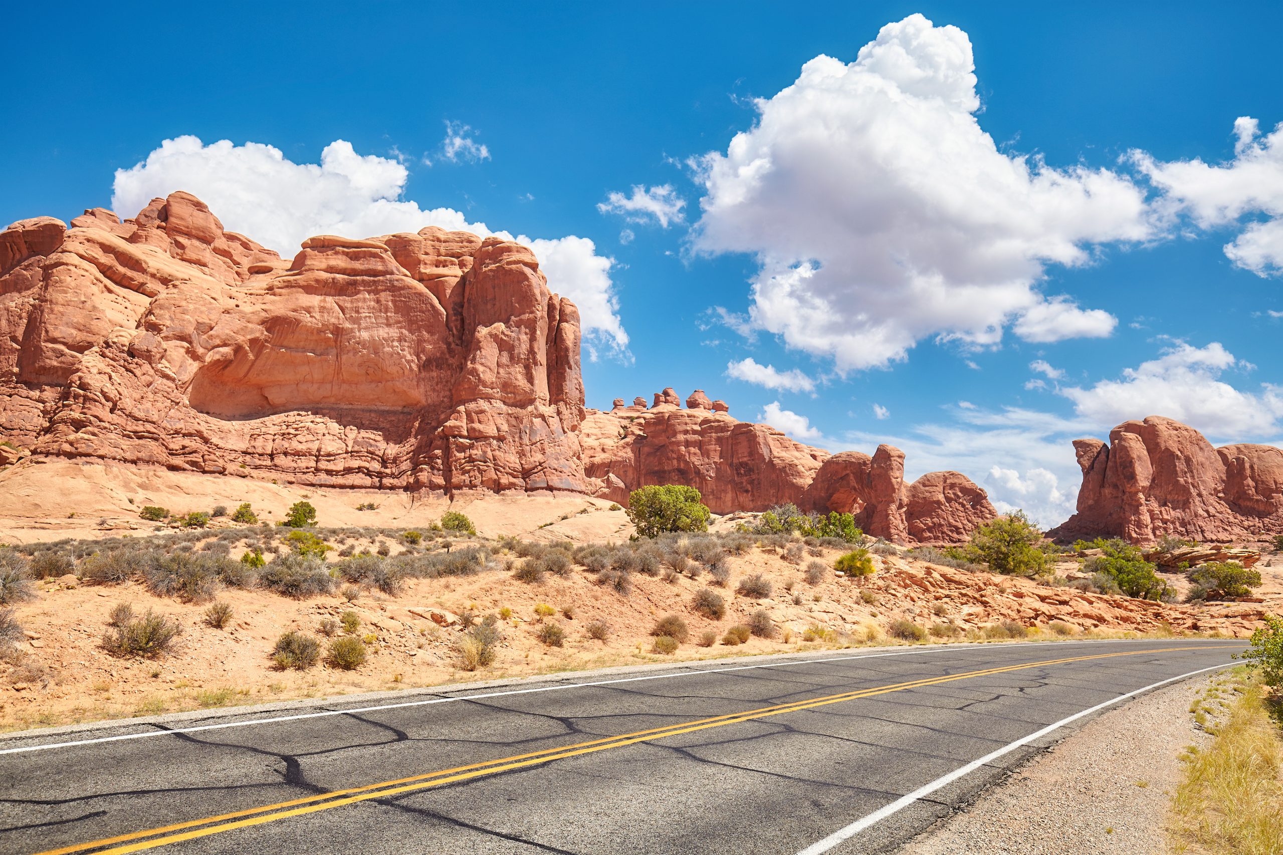 Scenic highway through red sandstone formations in the American Southwest desert