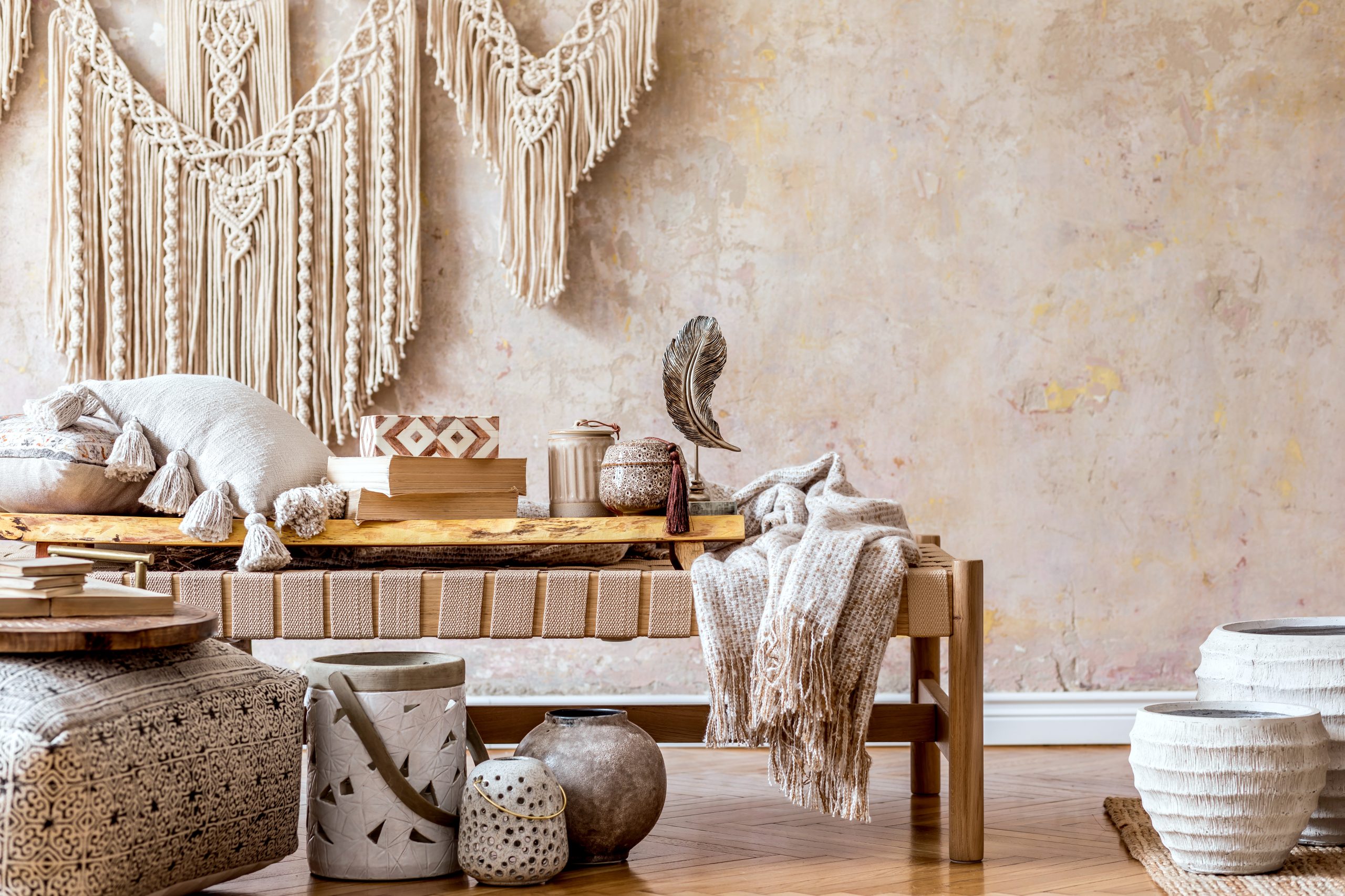 Warm boho americana room with large macrame wall hanging, earthy tones and handmade accessories