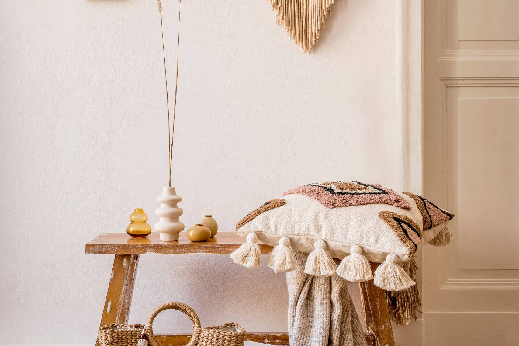 Boho americana living room corner with macrame wall hanging, woven rug and natural accessories