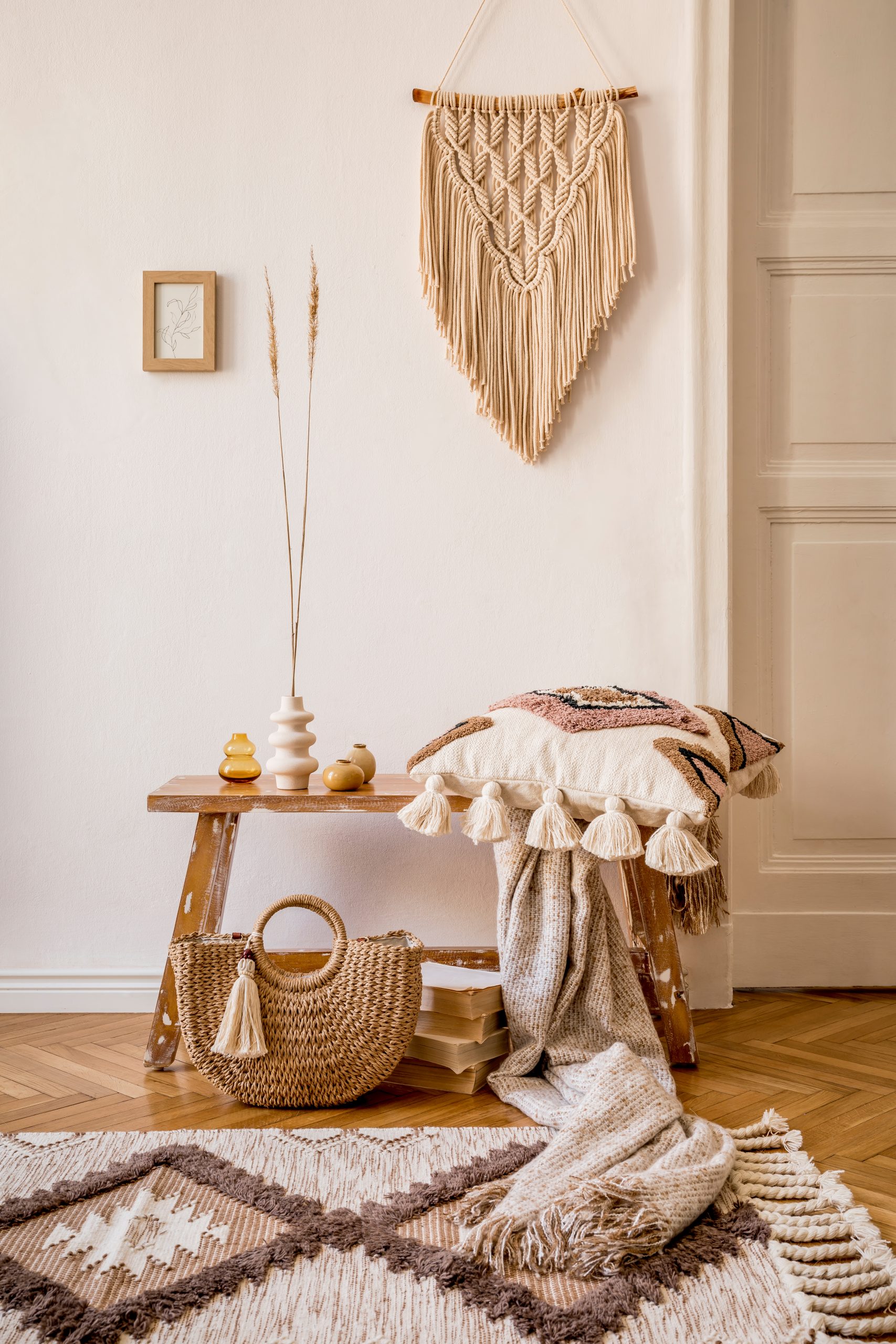 Boho americana living room corner with macrame wall hanging, woven rug and natural accessories
