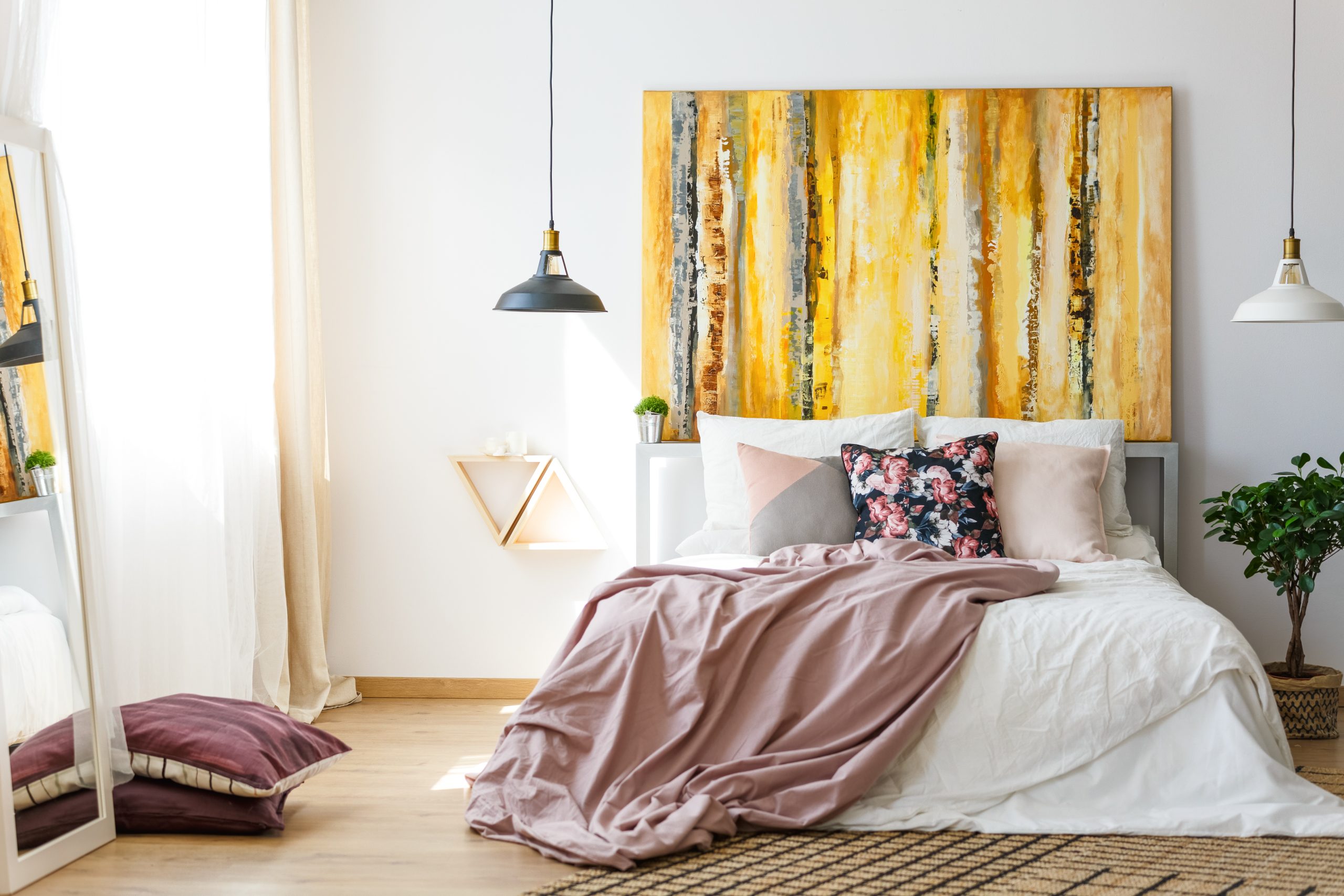 Cozy bedroom with warm golden tones and abstract wall art in americana style